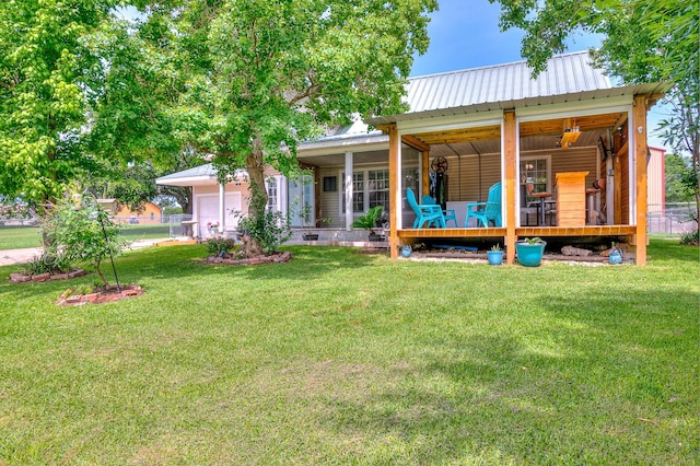 20 Clearview St, Point Blank, TX 77364 - rear view of house featuring an attached garage, metal roof, and covered porch