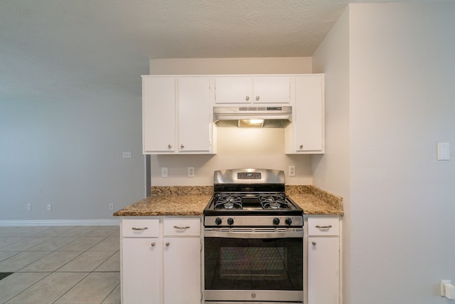 423 N Vista Dr, Houston, TX 77073 - kitchen featuring stainless steel range with gas stovetop, under cabinet range hood, white cabinets, baseboards, and light tile patterned flooring