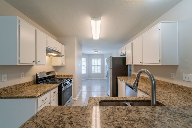 423 N Vista Dr, Houston, TX 77073 - kitchen with stainless steel appliances, under cabinet range hood, a sink, white cabinets, and light tile patterned floors