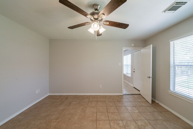 423 N Vista Dr, Houston, TX 77073 - empty room featuring a ceiling fan, light tile patterned floors, and baseboards