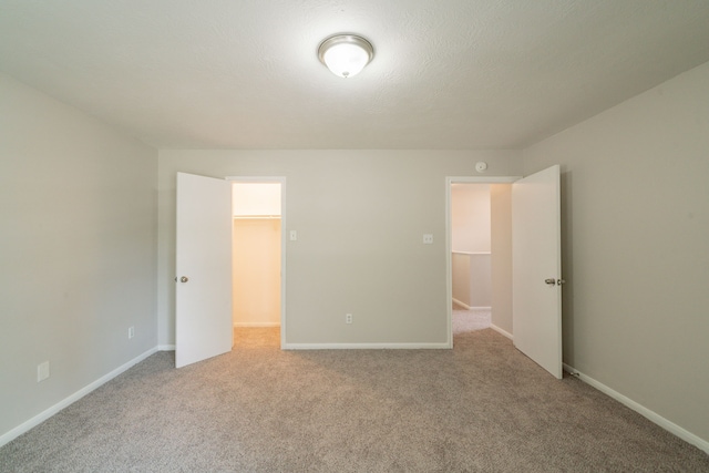 423 N Vista Dr, Houston, TX 77073 - unfurnished bedroom with carpet, a walk in closet, and baseboards