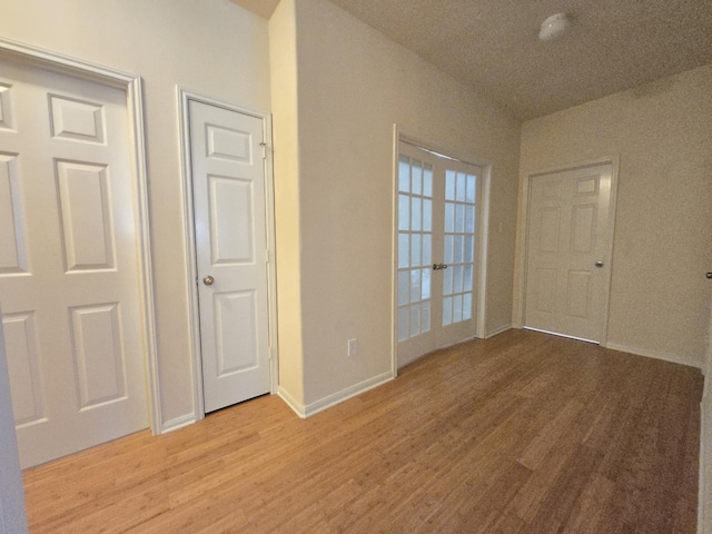 17427 N Riata Lake Dr, Cypress, TX 77433 - spare room featuring light wood-type flooring, baseboards, and french doors
