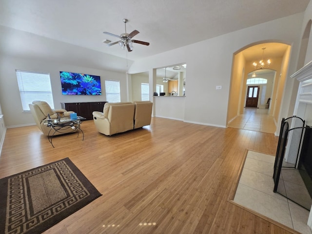 17427 N Riata Lake Dr, Cypress, TX 77433 - living area featuring arched walkways, light wood finished floors, ceiling fan, and baseboards