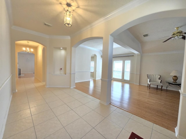 17427 N Riata Lake Dr, Cypress, TX 77433 - spare room with light tile patterned flooring, arched walkways, ceiling fan, ornamental molding, and baseboards