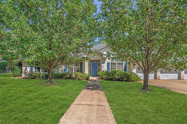 627 Shoreline Dr, Brookeland, TX 75931 - view of property hidden behind natural elements with driveway, a front lawn, and brick siding