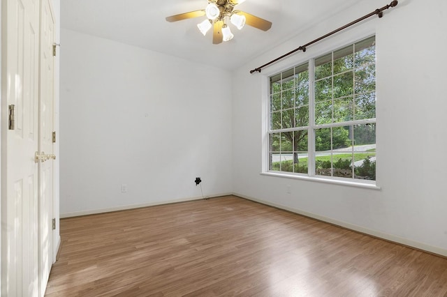 627 Shoreline Dr, Brookeland, TX 75931 - unfurnished room with plenty of natural light, wood finished floors, a ceiling fan, and baseboards