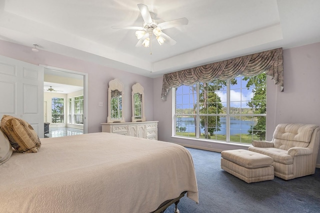 627 Shoreline Dr, Brookeland, TX 75931 - bedroom with a raised ceiling, multiple windows, carpet, and ceiling fan