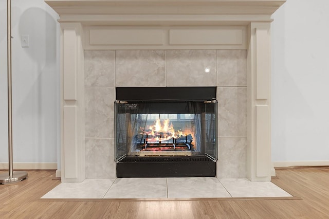 627 Shoreline Dr, Brookeland, TX 75931 - detailed view of wood finished floors, a tile fireplace, and baseboards