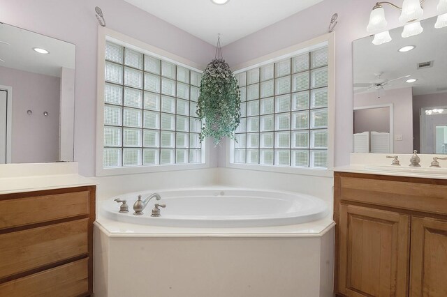 627 Shoreline Dr, Brookeland, TX 75931 - bathroom featuring vanity, plenty of natural light, a garden tub, ceiling fan, and recessed lighting