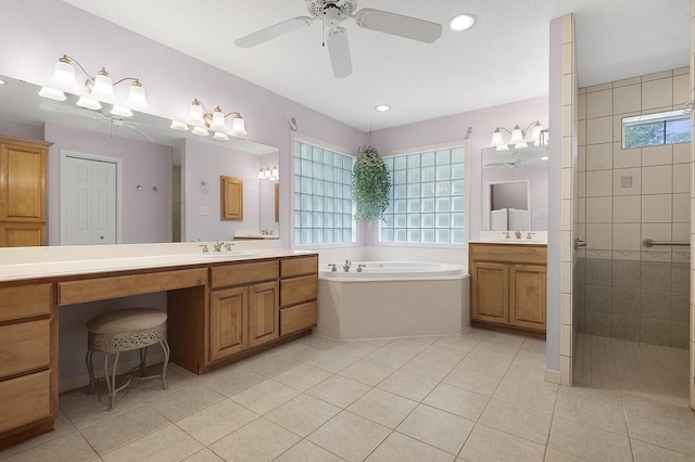627 Shoreline Dr, Brookeland, TX 75931 - bathroom with a bath, a tile shower, two vanities, tile patterned floors, and ceiling fan