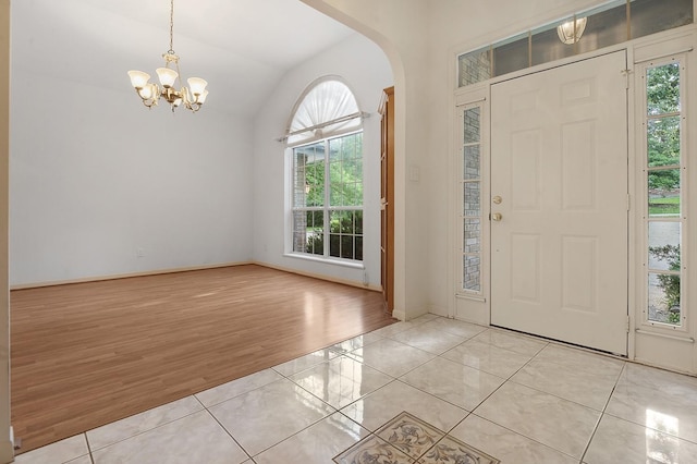 627 Shoreline Dr, Brookeland, TX 75931 - foyer entrance with plenty of natural light, light tile patterned flooring, arched walkways, and lofted ceiling