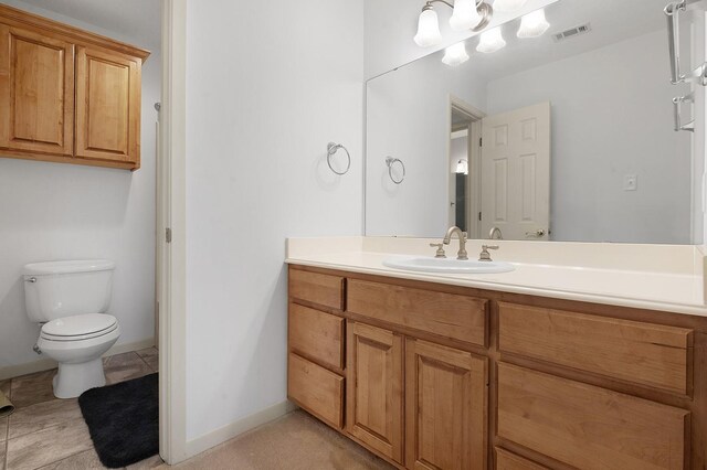 627 Shoreline Dr, Brookeland, TX 75931 - bathroom featuring vanity, toilet, and baseboards