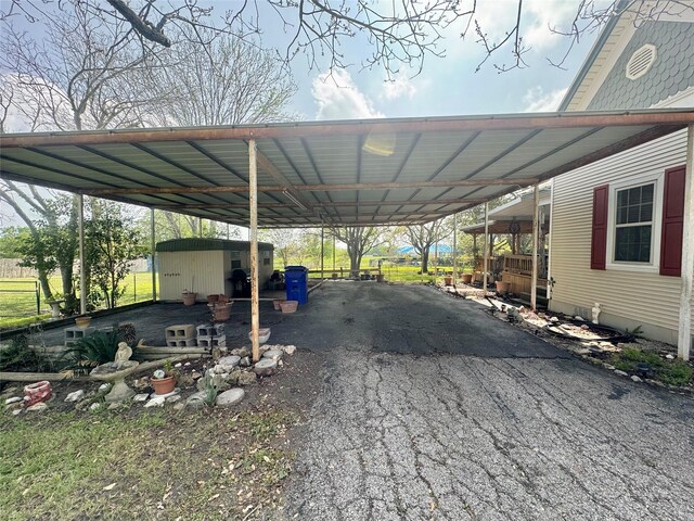 706 W St, Yoakum, TX 77995 - view of car parking featuring driveway and a storage unit