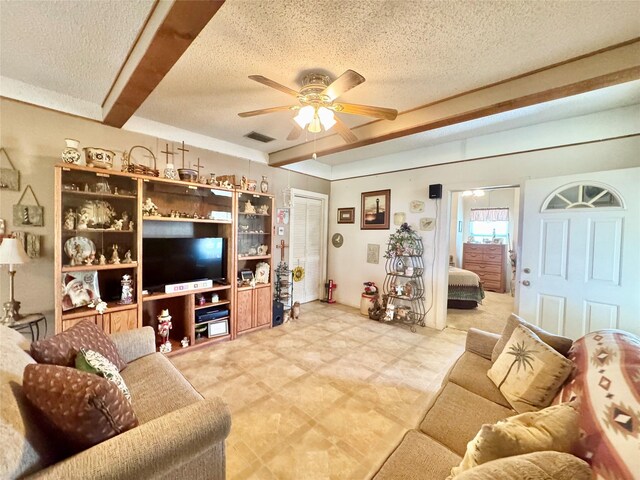 706 W St, Yoakum, TX 77995 - living room featuring a ceiling fan and a textured ceiling