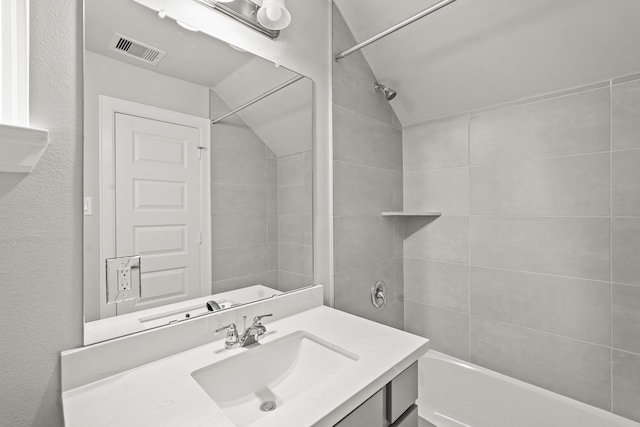 3022 Ventas Dr, Houston, TX 77047 - bathroom with vanity, bathing tub / shower combination, and vaulted ceiling