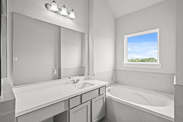 3022 Ventas Dr, Houston, TX 77047 - bathroom featuring a garden tub, vanity, and lofted ceiling