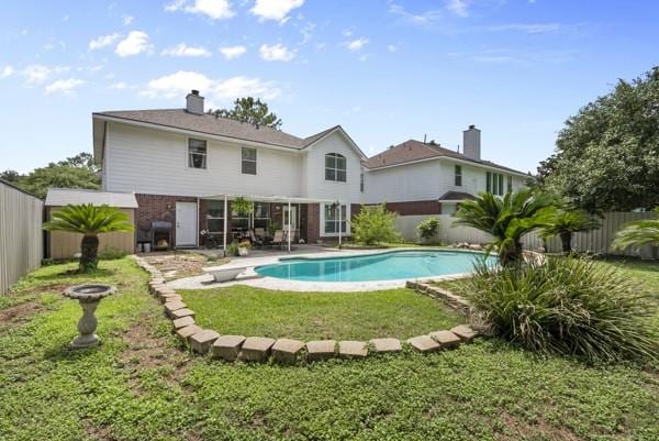 23706 River Place Dr, Katy, TX 77494 - rear view of house featuring a chimney and a patio area