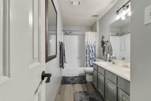 23706 River Place Dr, Katy, TX 77494 - full bathroom with wood finished floors, shower / bath combination with curtain, toilet, and double vanity