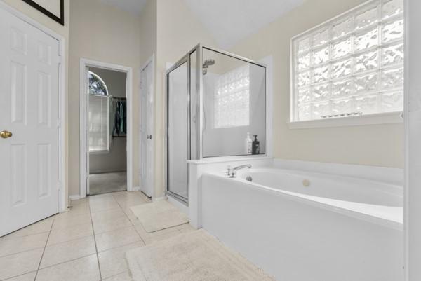 23706 River Place Dr, Katy, TX 77494 - full bathroom with a stall shower, tile patterned flooring, and a bath