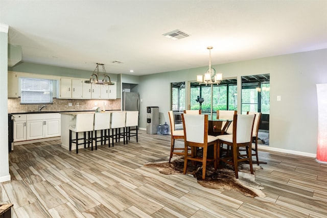 6915 Oak Bend Dr, Alvin, TX 77511 - dining space with a chandelier, wood finish floors, and baseboards