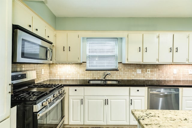 6915 Oak Bend Dr, Alvin, TX 77511 - kitchen with stainless steel appliances, a sink, tasteful backsplash, and dark stone counters