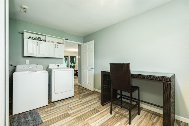 6915 Oak Bend Dr, Alvin, TX 77511 - washroom with washing machine and clothes dryer, light wood finished floors, cabinet space, and baseboards