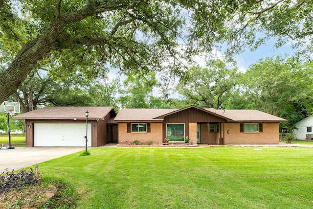 6915 Oak Bend Dr, Alvin, TX 77511 - ranch-style home with a garage, concrete driveway, a front yard, and brick siding