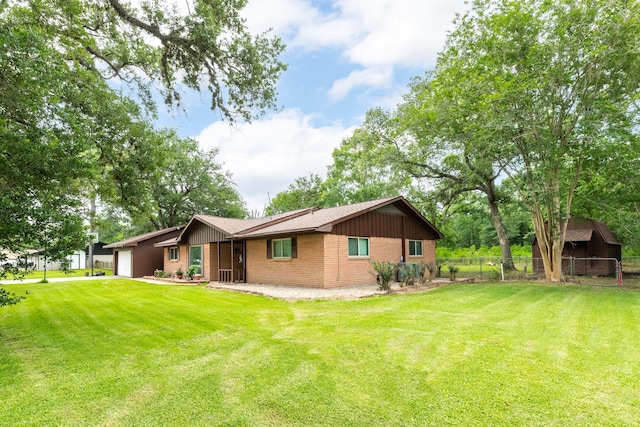 6915 Oak Bend Dr, Alvin, TX 77511 - rear view of property with a garage, brick siding, and board and batten siding