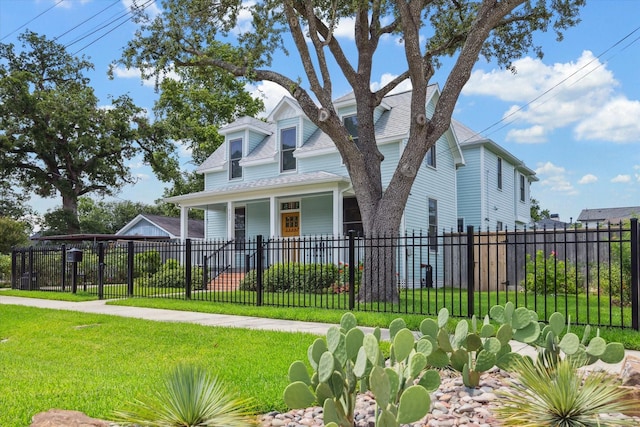 523 W 15th St, Houston, TX 77008 - view of front facade with a fenced front yard, a shingled roof, and covered porch