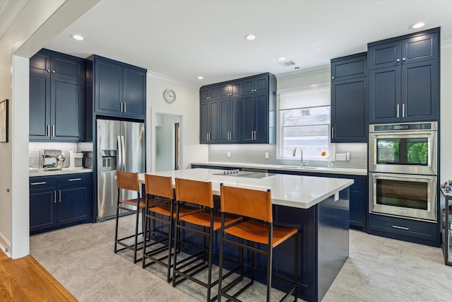 523 W 15th St, Houston, TX 77008 - kitchen featuring stainless steel appliances, decorative backsplash, a center island, a kitchen bar, and crown molding