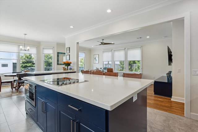 523 W 15th St, Houston, TX 77008 - kitchen featuring black electric cooktop, crown molding, open floor plan, a chandelier, and a center island