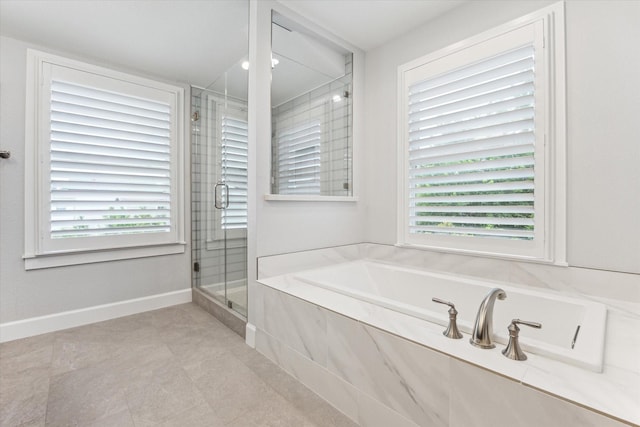523 W 15th St, Houston, TX 77008 - bathroom with a stall shower, a garden tub, and tile patterned floors