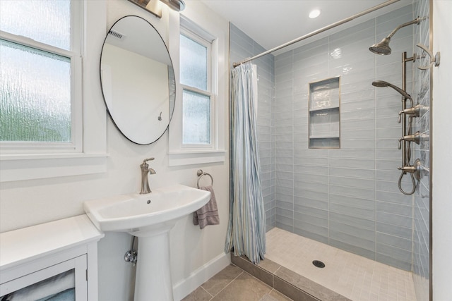 523 W 15th St, Houston, TX 77008 - bathroom featuring healthy amount of natural light, tiled shower, and tile patterned flooring