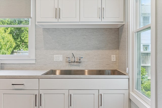 523 W 15th St, Houston, TX 77008 - kitchen with light countertops, white cabinets, and tasteful backsplash