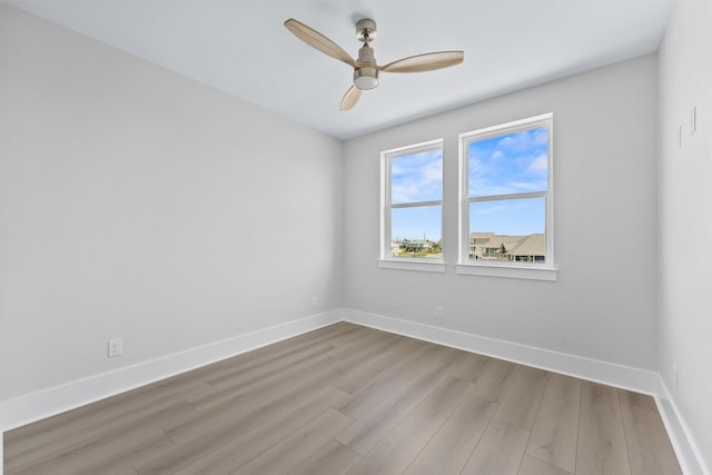 4010 Miramar Ct, Galveston, TX 77554 - spare room featuring wood finished floors, baseboards, and a ceiling fan