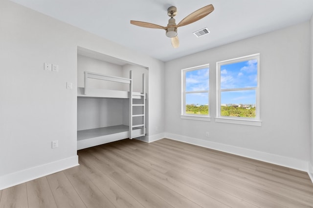 4010 Miramar Ct, Galveston, TX 77554 - unfurnished bedroom featuring baseboards, wood finished floors, and ceiling fan