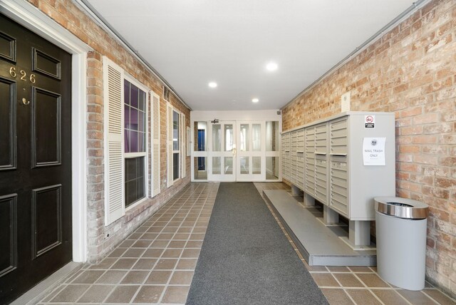 355 N Post Oak Ln Unit 743, Houston, TX 77024 - view of community featuring mail area, brick wall, and recessed lighting