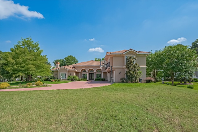 8522 Haven Trl, Tomball, TX 77375 - rear view of property with a tile roof, a lawn, and stucco siding