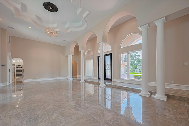 8522 Haven Trl, Tomball, TX 77375 - empty room featuring marble tiled floors, a towering ceiling, ornate columns, and recessed lighting