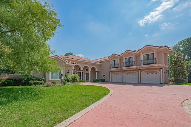 8522 Haven Trl, Tomball, TX 77375 - mediterranean / spanish-style house with stucco siding, a balcony, a tiled roof, driveway, and a garage