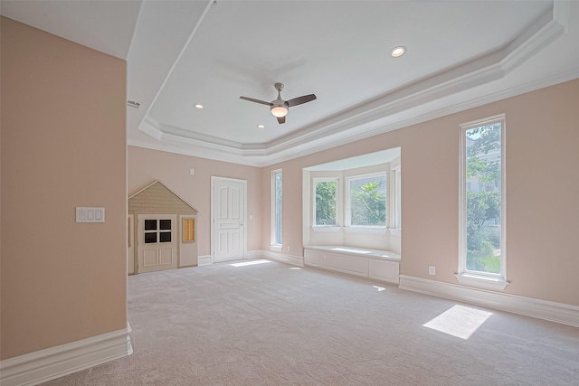 8522 Haven Trl, Tomball, TX 77375 - unfurnished living room with a raised ceiling, light carpet, baseboards, ceiling fan, and ornamental molding