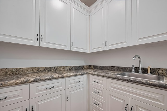 8522 Haven Trl, Tomball, TX 77375 - kitchen with a sink, dark countertops, and white cabinetry