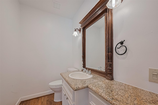 8522 Haven Trl, Tomball, TX 77375 - half bath with vanity, wood finished floors, toilet, and baseboards