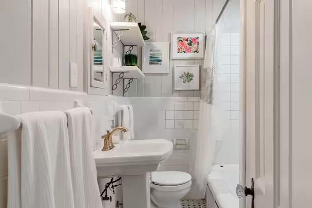 701 Gilchrist, College Station, TX 77840 - bathroom featuring toilet and shower / bathtub combination with curtain
