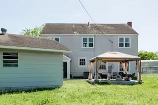 701 Gilchrist, College Station, TX 77840 - rear view of house with a gazebo, a lawn, a patio, and a chimney
