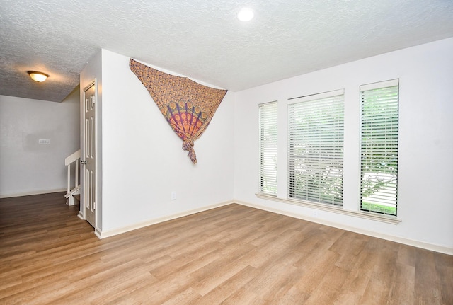 16323 Elmwood Point Ln, Sugar Land, TX 77498 - spare room featuring wood finished floors, a textured ceiling, and healthy amount of natural light