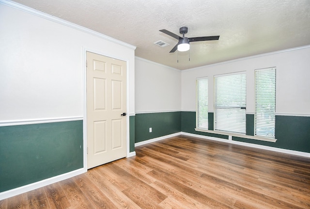 16323 Elmwood Point Ln, Sugar Land, TX 77498 - spare room with a ceiling fan, ornamental molding, wood finished floors, baseboards, and a textured ceiling