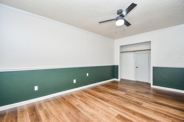 16323 Elmwood Point Ln, Sugar Land, TX 77498 - unfurnished bedroom with wood finished floors, a textured ceiling, crown molding, baseboards, and a closet