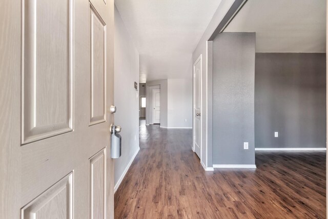 16531 Silla Ridge Ct, Houston, TX 77049 - hall featuring baseboards and dark wood-style floors