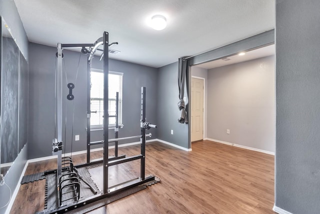 16531 Silla Ridge Ct, Houston, TX 77049 - exercise room with baseboards and wood finished floors